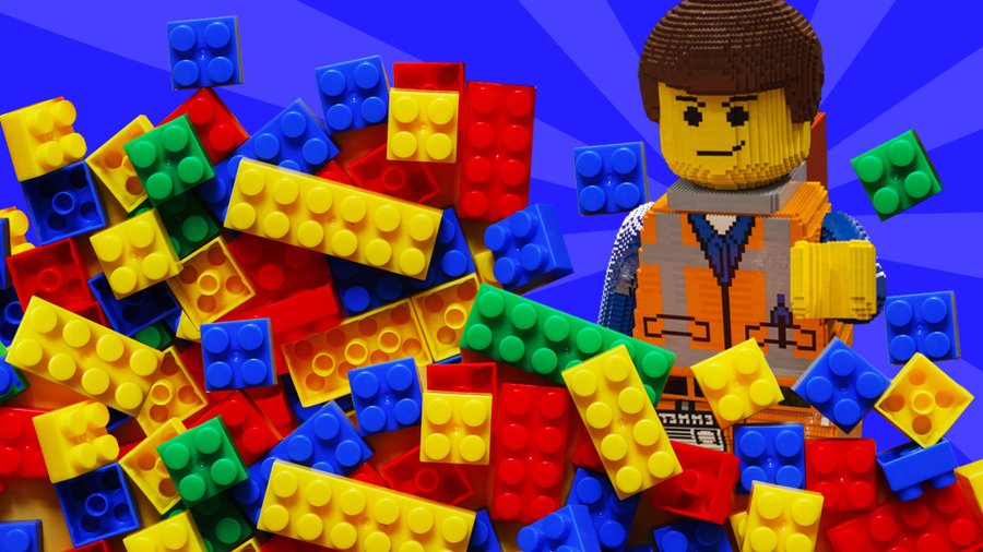 LEGO bricks and minifigure on a blue background