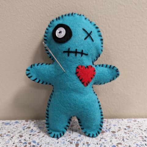 monster pincushion with a pin stuck in it