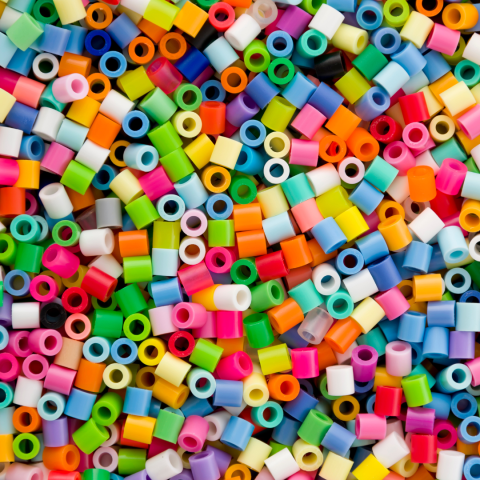 a scattered pile of colorful Perler beads