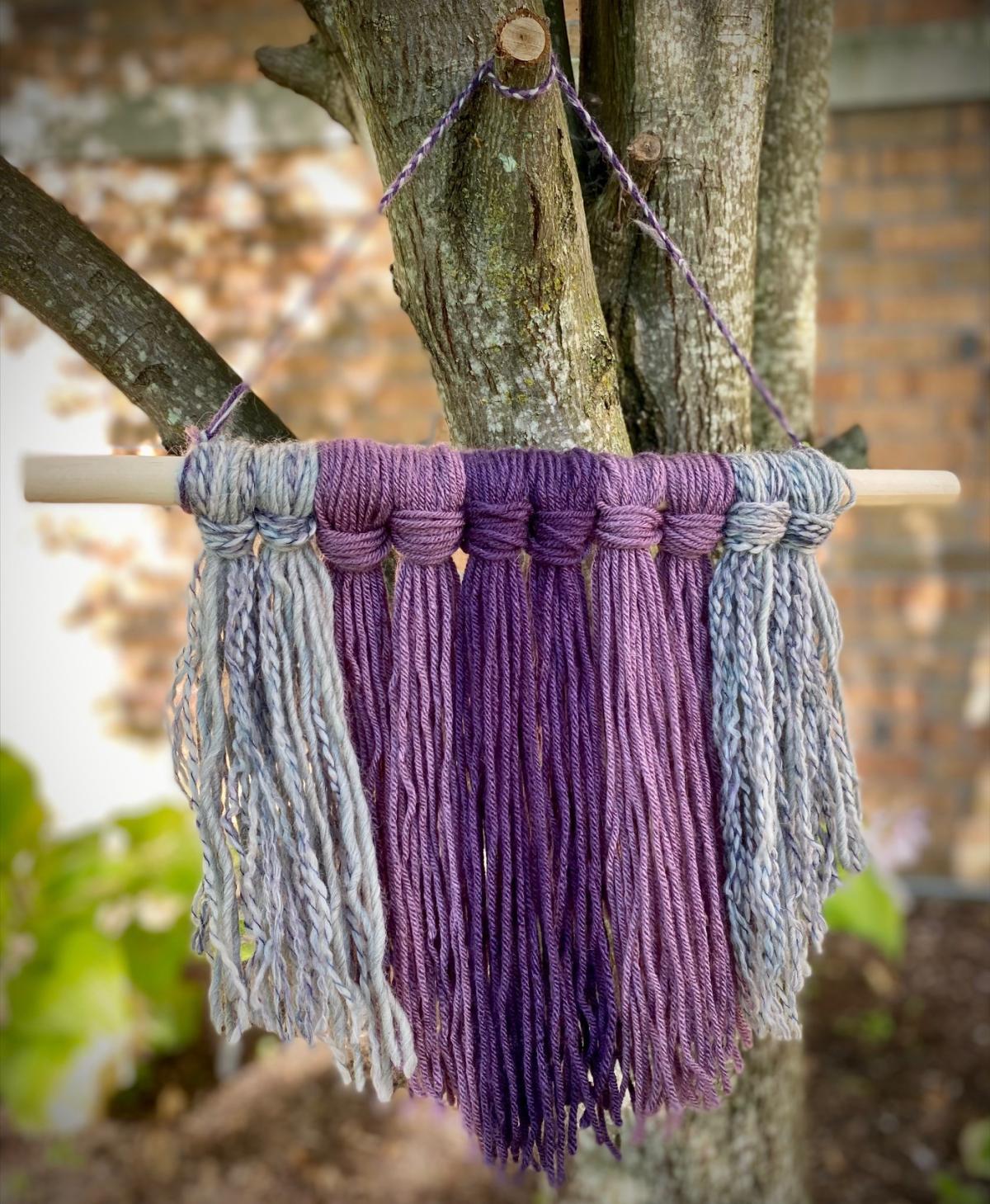 purple and grey yarn wall hanging